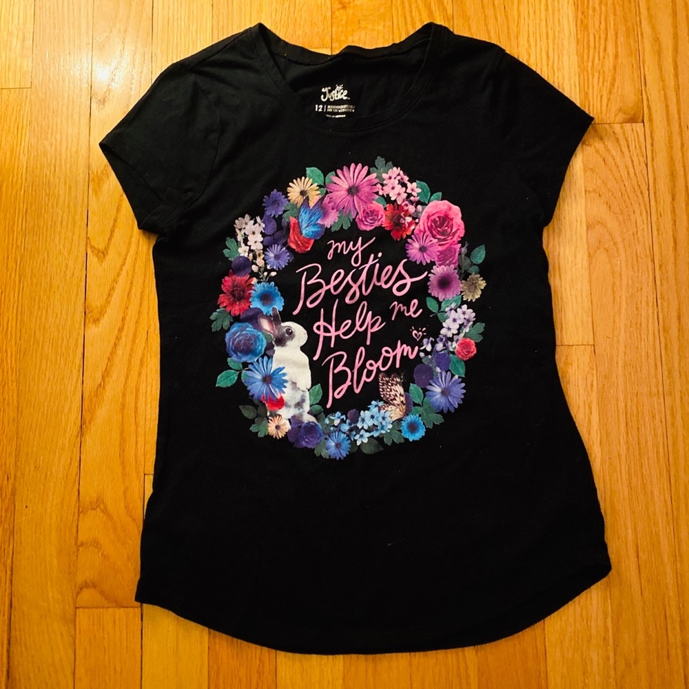 A black tee with a flower wreath on it